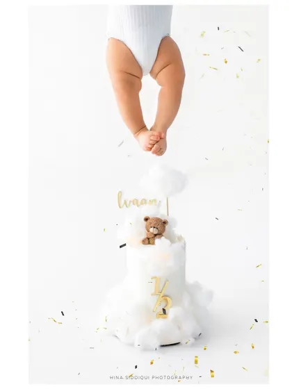 A duplicate of the creative half birthday cake shot, emphasizing its artistic appeal. This type of conceptual photography adds a unique touch to your baby's gallery.