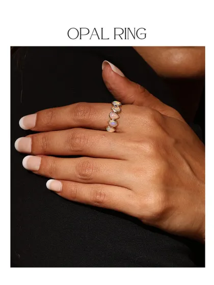 The Opal Ring from the Power Stones collection, worn on the hand. The iridescent play-of-color in the opals makes this a truly magical piece.