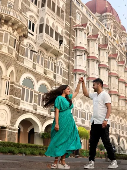 We use iconic locations like Mumbai's Taj Mahal Palace Hotel to create dramatic and memorable pre-wedding photographs. This shot captures a dynamic, joyful dance, turning a city landmark into a personal part of your story.