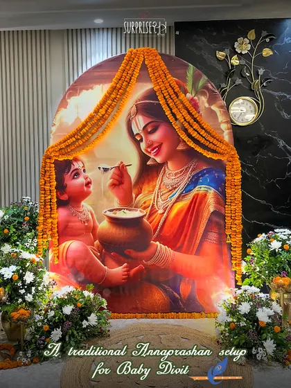 A traditional Annaprashan setup for Baby Divit. The beautiful backdrop of Yashoda feeding Krishna, framed by marigold garlands, created a divine atmosphere for this important milestone.