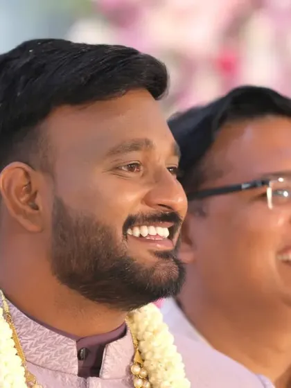 A candid shot of the groom sharing a laugh with a friend or family member. We document the joy of everyone celebrating your special day.