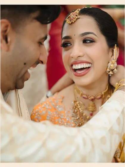 A tight close-up on the bride's ecstatic laugh, one of those priceless expressions that make a wedding album special.