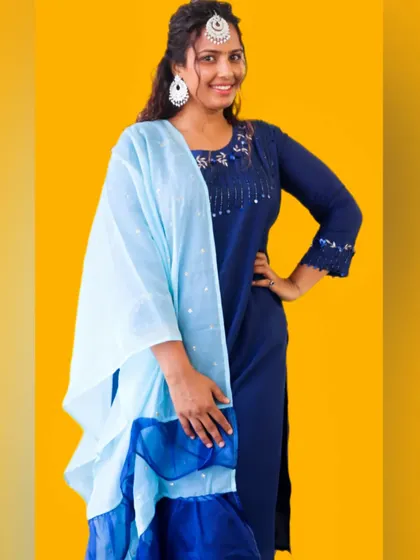 A full look at my festive suit. The combination of dark blue and sky blue is classic and elegant. I sourced the jewelry locally, proving you can create a high-impact look by mixing and matching.