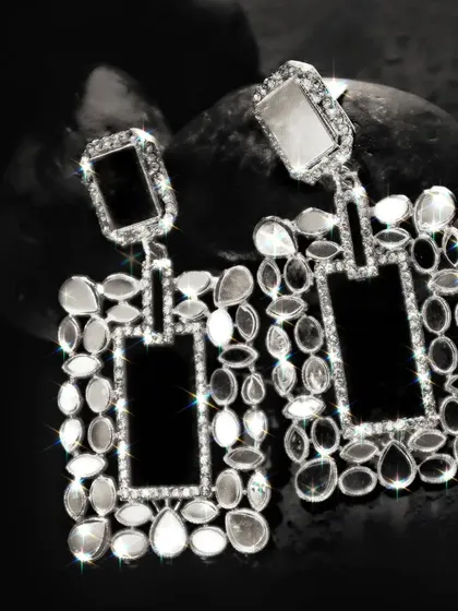 A high-contrast black and white image of the statement earrings, where the sparkle effect is enhanced to create a glamorous, eye-catching look.