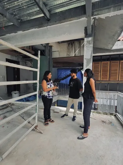 Gayathri discussing design details with our young architects on the balcony of a building under construction. This collaborative, on-site process is key to problem-solving and refining the design in real-time.