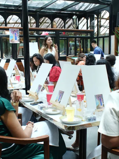A wide shot of a large birthday paint party we hosted at Keibaa. The beautiful venue, combined with the creative energy of the guests, made for an absolutely unforgettable event.