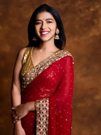 Looking like she stepped out of a painting, our client is a dream in this beautiful maroon georgette saree with a heavy gold border and a sequined blouse.