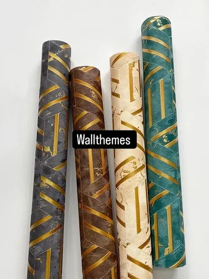 A collection of four geometric wallpaper rolls with a 3D block pattern and gold accents, in grey, brown, beige, and teal.