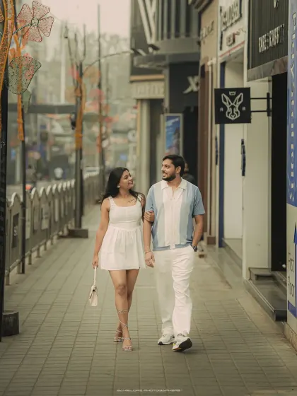 A pre-wedding stroll through the city streets. This candid shot captures the couple's easy chemistry and modern style.