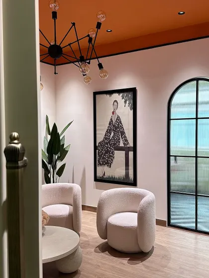 A glimpse into our studio's lounge area, designed to be a comfortable and inspiring space for our team and clients, with an orange ceiling and curated art.