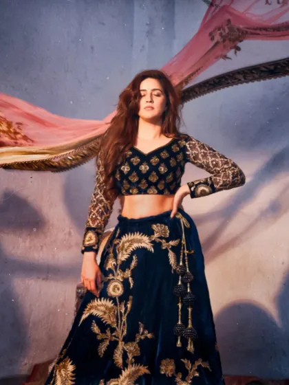 A dramatic pose from Vaidehi Parshurami in the navy and pink velvet lehenga. Wear what the stars wear, without the starry price tag.