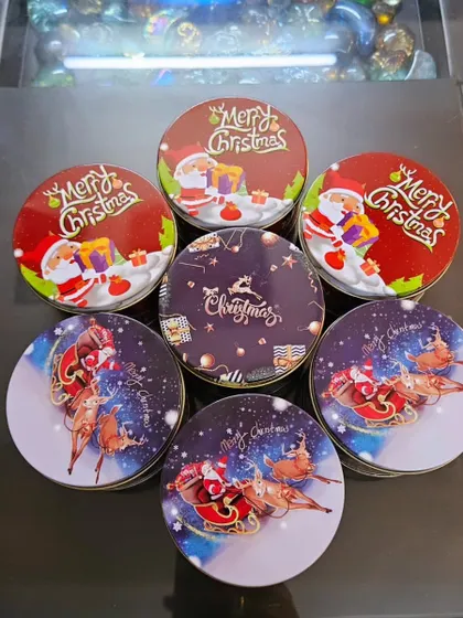 A collection of my Christmas edition chocolate tins. Each tin features a different festive design, from Santa Claus to reindeer, and is perfect for small, thoughtful gifts.