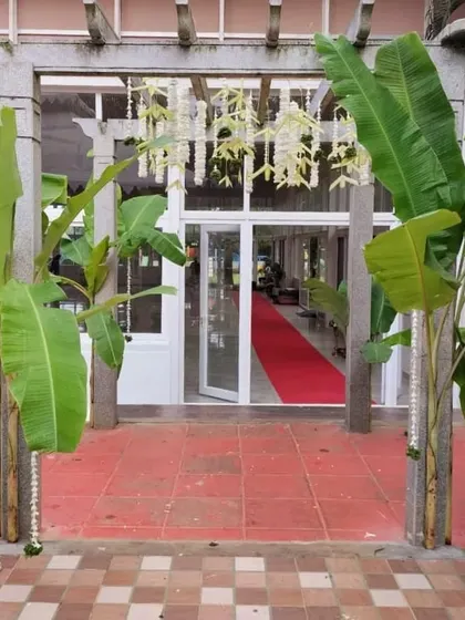 A simple and traditional entrance decor featuring banana plants and hanging jasmine garlands, welcoming guests to the celebration.