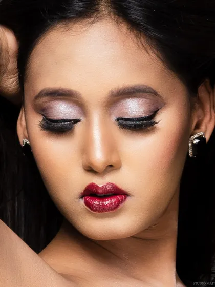 A close-up beauty shot focusing on a glamorous makeup look with shimmery eyeshadow and bold red lips. I work closely with makeup artists to ensure their work is captured perfectly.