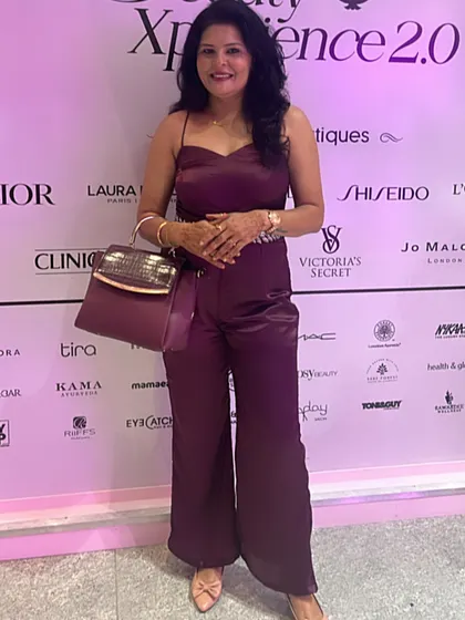 A full-length view of the wine-colored satin jumpsuit, paired with a matching handbag. This shows how I create a complete, coordinated look.