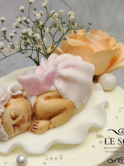 I was so happy to make this baptism cake for baby Renée. This 3 kg two-tier Lemon Blueberry Cream Cheese cake features a delicate sleeping baby figurine, an angel plaque, and is adorned with fresh peach roses and baby's breath.