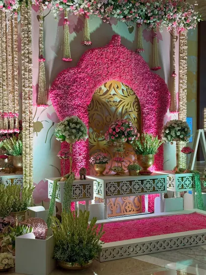 Another angle of the opulent floral corner, showcasing the hanging flower strings and the intricate white console tables that add to the traditional, luxurious feel.