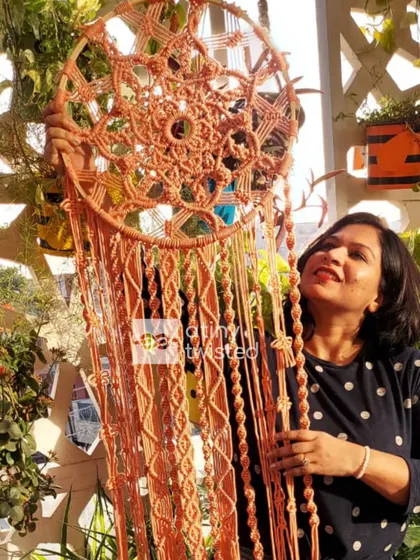 Here I am with one of my large, custom-made dreamcatchers. I love how the sunlight catches the details of the knots. These can be made in any size and color to match your vision.