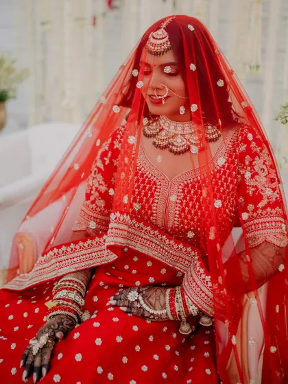 A serene moment of the bride under her veil. The soft light and her gentle expression create a peaceful and beautiful portrait before the ceremony begins.