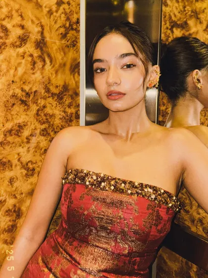 An elevator selfie moment. Even in candid shots, the beautiful texture and color of the Banarasi dress shine through.