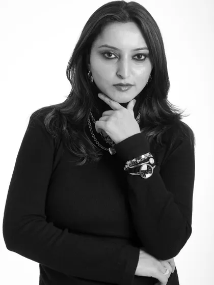 A classic studio headshot in black and white. The clean background and direct gaze make for a strong, professional portrait.