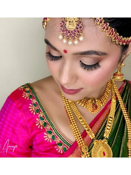 A detailed close-up of the eye makeup. The long, fluttery lashes and clean lines create a captivating look that enhances her eyes.
