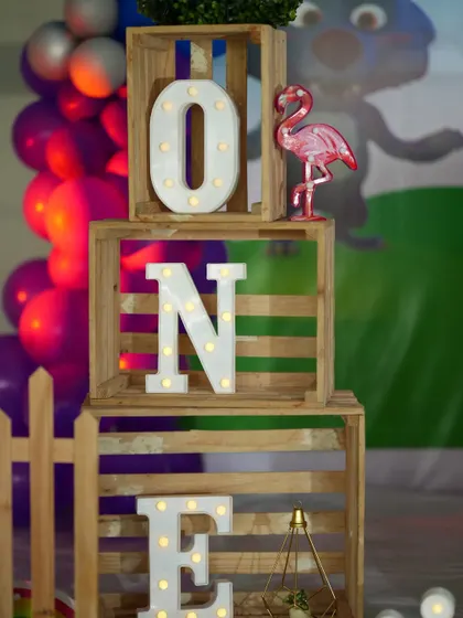 Our "ONE" marquee letters stacked in wooden crates. This is a rustic and charming way to display the milestone age at a first birthday party.