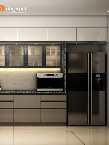 This L-shaped kitchen combines beige cabinets with black-framed glass units. The layout is designed to accommodate a large refrigerator and built-in oven, ensuring a seamless and integrated look.