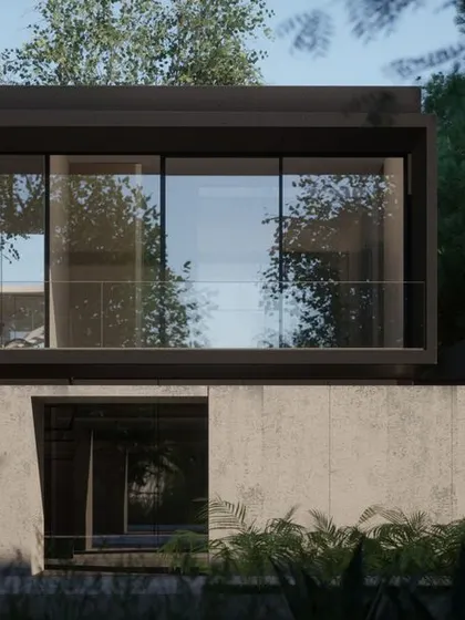 A detail of the residence, showing the clean lines and the interplay of solid concrete and transparent glass. The design creates a sense of tranquility and connection to the surrounding nature.