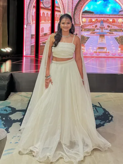 Dressed for a Sangeet night with a stunning palace-themed LED backdrop. I always coordinate my attire to match the grandeur and theme of the wedding.