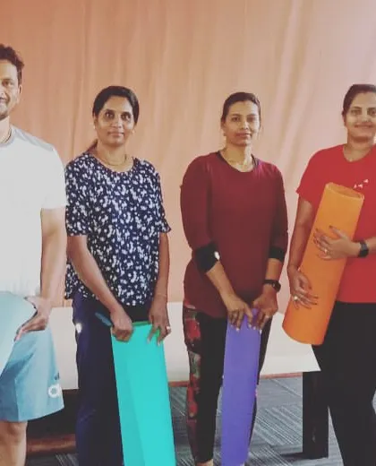 Our members ready for a yoga session, mats in hand. We welcome everyone, from complete beginners to those looking to deepen their practice, into our yoga community.