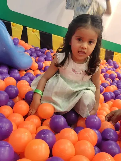 A candid moment in the ball pit. This area is perfect for toddlers and kids to explore textures and colors in a safe, contained space.
