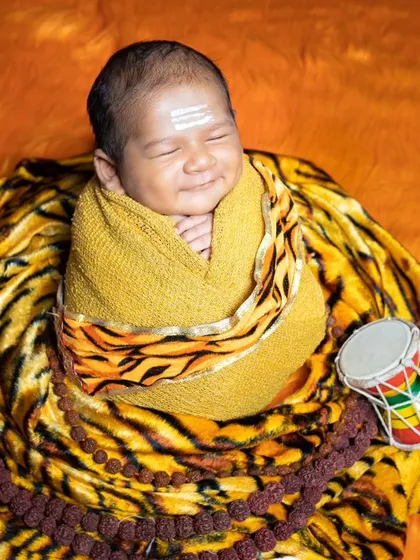 A beautiful sleeping portrait of a baby dressed as Lord Shiva, radiating peace and serenity.
