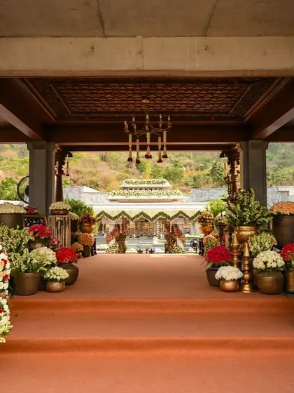 A closer view of the flower-lined entrance, with golden elephant statues adding a touch of royalty and tradition.