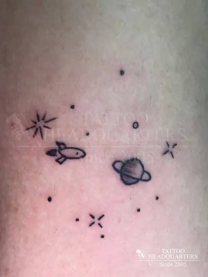 A tiny galaxy of minimalist symbols, including a rocket, a planet, and stars, creating a small cosmic scene.