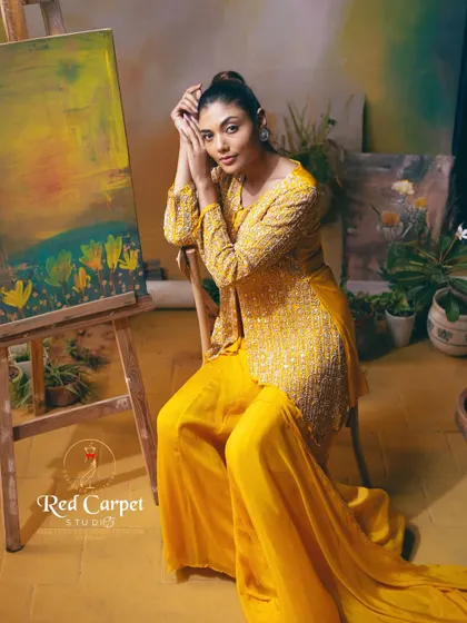 Another beautiful shot of the yellow palazzo set, where the model looks like a painting herself. The rich color and intricate embroidery are the highlights of this design.