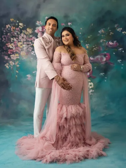 A classic couple's pose against a painterly floral backdrop. My goal is to make you feel comfortable and connected, resulting in maternity portraits that are both elegant and full of love.