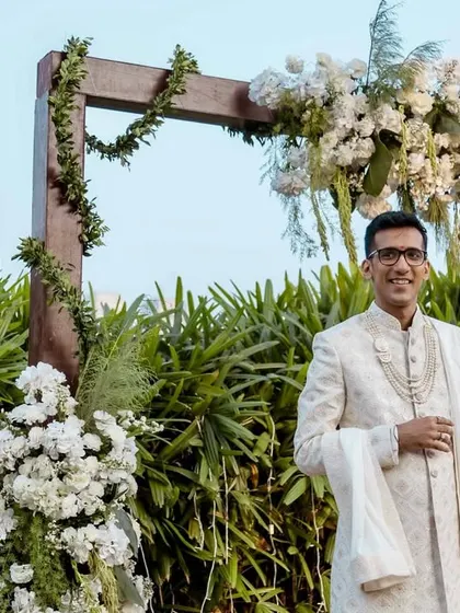 The groom waits patiently for his bride, his expression a mix of nervousness and excitement. A beautiful start to the bridal entry sequence.