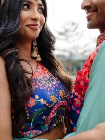 A close-up shot of a couple during their Mehendi, capturing the bride's joyful expression.