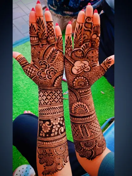 This intricate bridal mehandi features the name 'Ram' written in Hindi script, nestled within a heart. The design is packed with floral vines and geometric bands.