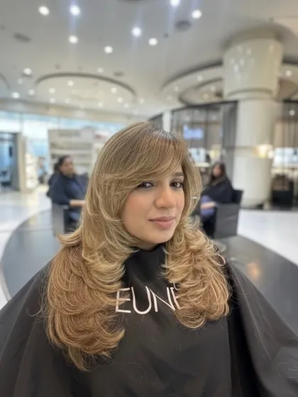 The finished blonde look. The combination of the layered cut and the bright color creates a style that is both beautiful and full of energy.