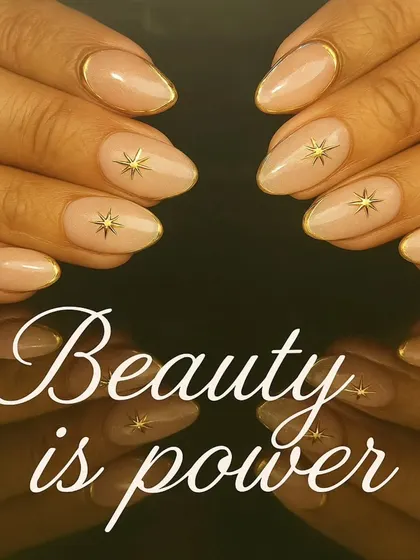 An elegant nude manicure with gold chrome outlines and delicate gold starburst accents.