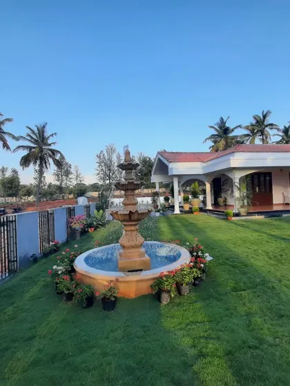 A sprawling residential property featuring a lush lawn, mature palm trees, and a classic tiered water fountain as the centerpiece. This project showcases my capability in executing large-scale landscape designs that include both softscaping and hardscaping elements.