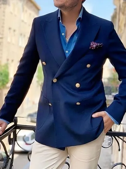 A navy double-breasted blazer is a versatile and powerful piece. Paired here with light trousers, it demonstrates a sophisticated business-casual look, perfect for making an impression.