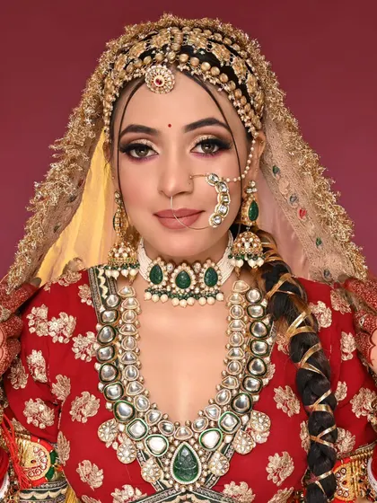 This full-look shot shows the unique braided hairstyle and the stunning gold matha patti, demonstrating a complete vision for the bride.