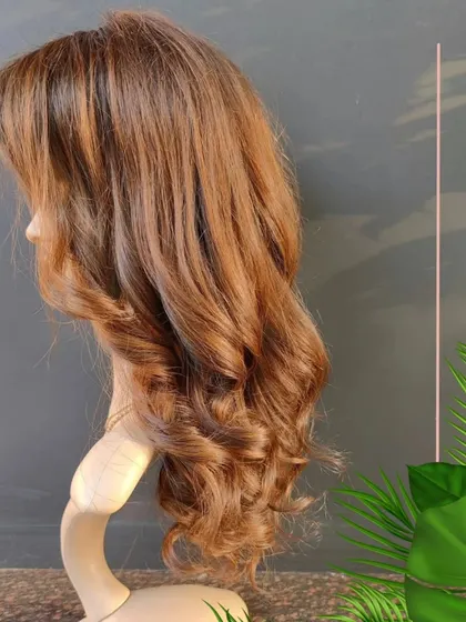 This creamy blonde wig is one of our bespoke creations. It is custom colored and styled with soft waves. We can create a wig that is tailored specifically to your desired look and style.
