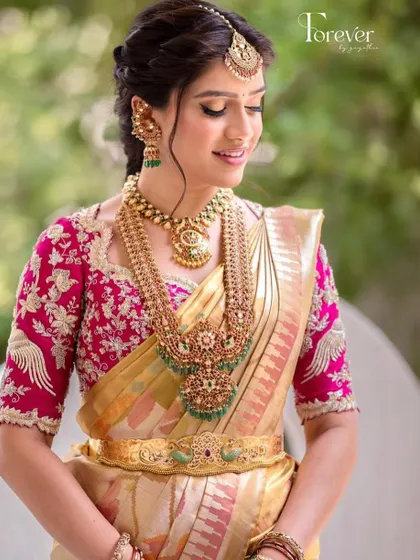 A close-up of the intricate embroidery on this pink bridal blouse. The detailed craftsmanship and beautiful design make it a true work of art.