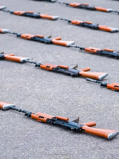 The tools of discipline. This photograph shows rifles laid out in perfect formation on the ground, mirroring the precision of the soldiers who carry them. It's a detail that speaks volumes about the preparation behind the parade.