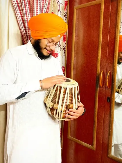A candid moment of reflection with my instrument. The tabla is more than wood and skin to me; it is a friend and a medium for my expression.