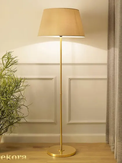 This sleek floor lamp with a brushed gold finish embodies modern elegance. Its slim profile and classic shade make it a perfect fit for tight corners or next to an armchair, providing refined task lighting.